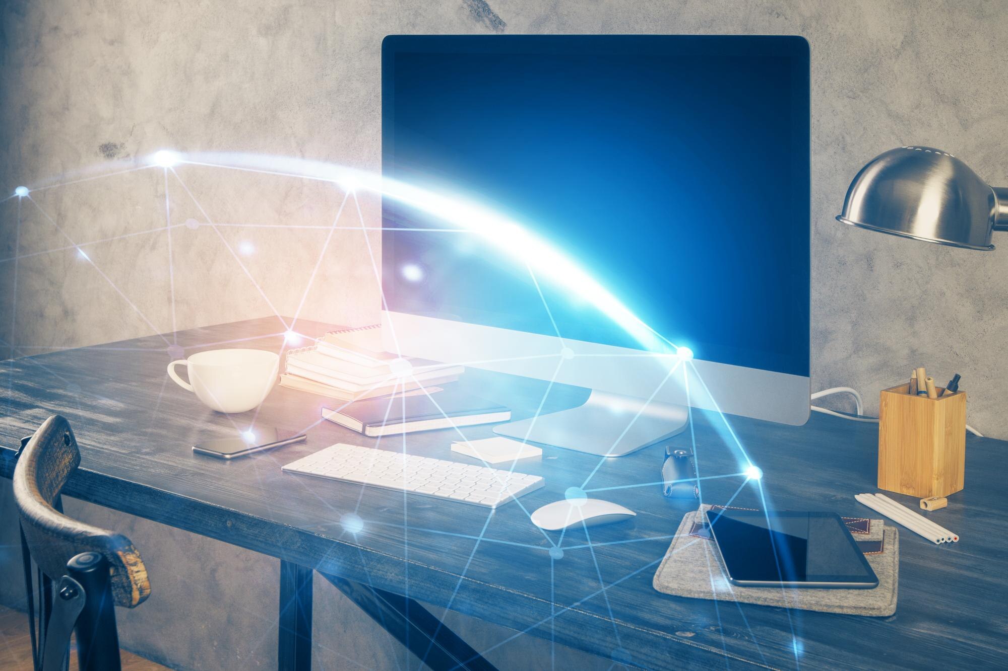 Moderne skrivebord med en stor skjerm, en kaffekopp, notatblokker og et nettbrett, omgitt av et lysende nettverksikon.